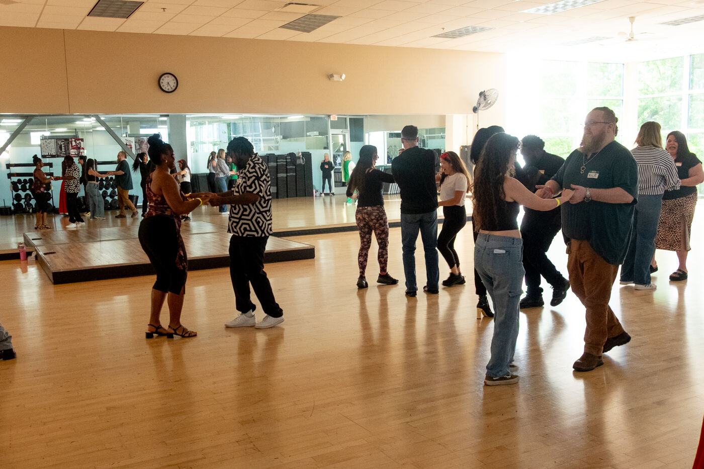 A wide view of couples dancing across the Social Spark floor